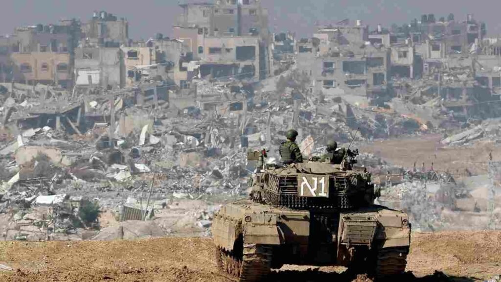 An Israeli Merkava Tank overlooks a destroyed Gaza