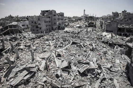 Two men, right, stand in the rubble of destroyed buildings in the Shuja'iyya neighborhood of east Gaza City duringa 12-hour ceasefire on July 26.