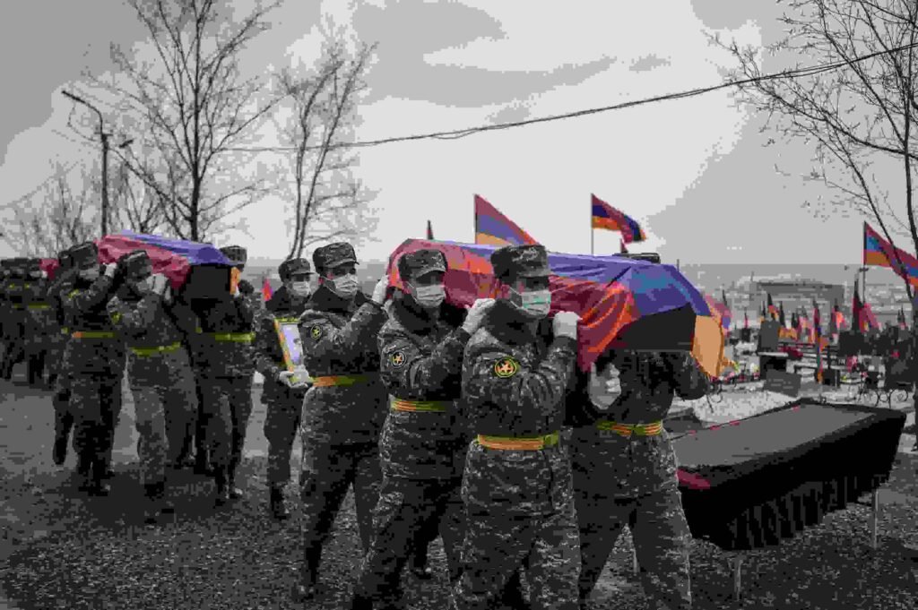 Armenian troops laying their dead to rest after clashes with Azeri forces in Nogorno-Karabakh